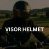 motorcyclist wearing a visor helmet while riding his bike